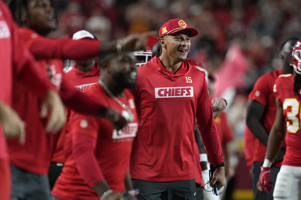 Kansas City Chiefs quarterback Patrick Mahomes celebrates on the sidelines during the first half of an NFL preseason football game against the Chicago Bears