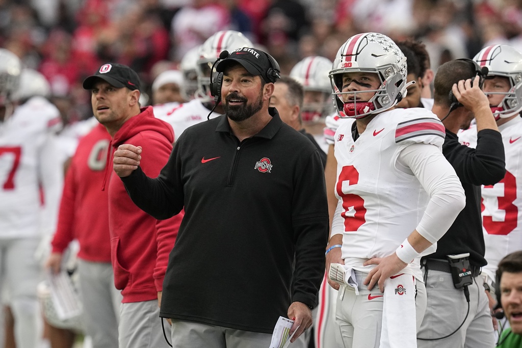 Ohio State head coach Ryan Day talks with quarterback Kyle McCord (6) during the first half of an NCAA college football game against Purdue, Saturday, Oct. 14, 2023, in West Lafayette, Ind.