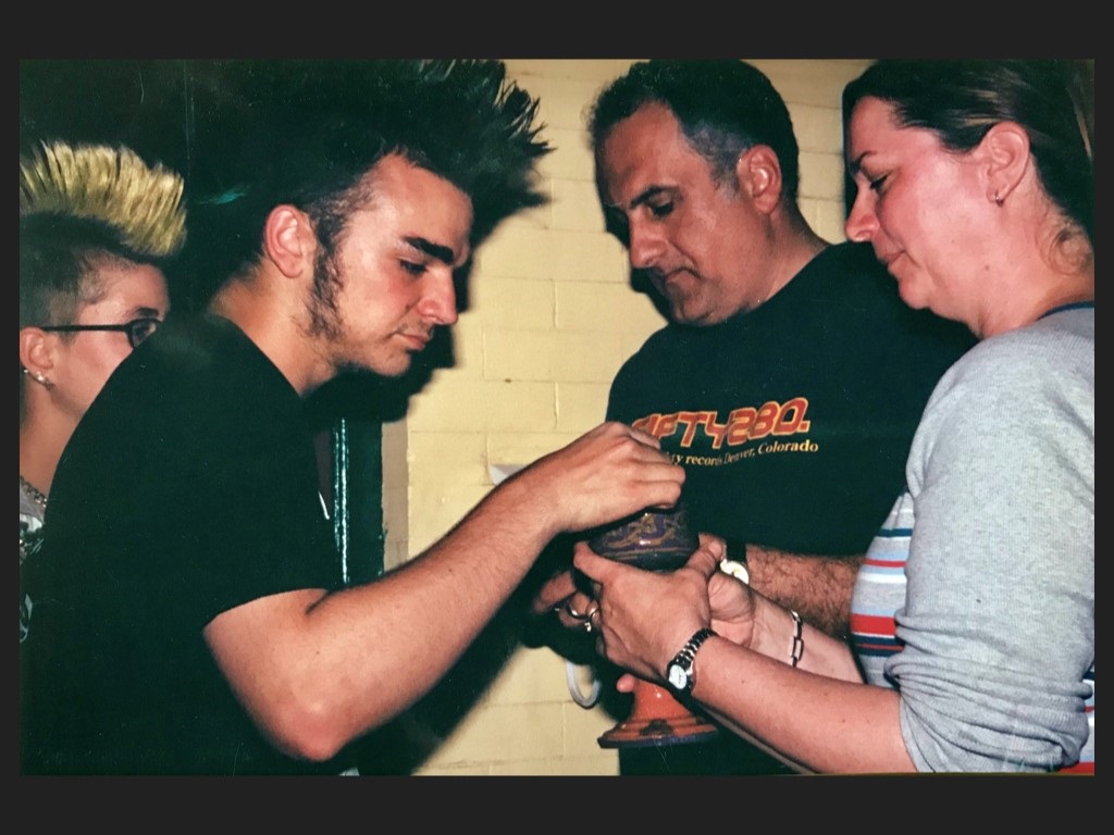 Mike Sares delivering communion to members of Scum of he Earth Church.