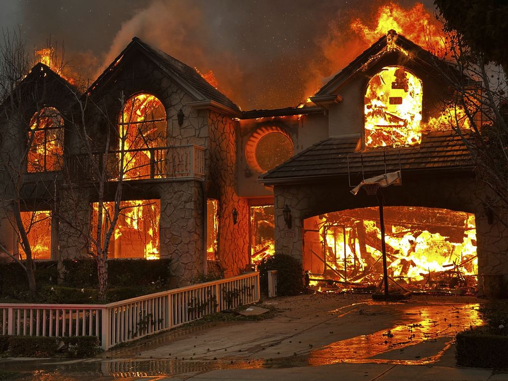 The Palisades Fire burns a structure in the Pacific Palisades neighborhood of Los Angeles