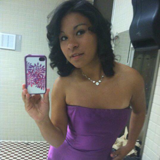 Carmen posing in a dress she was given through the Fairy Godmother Boutique.